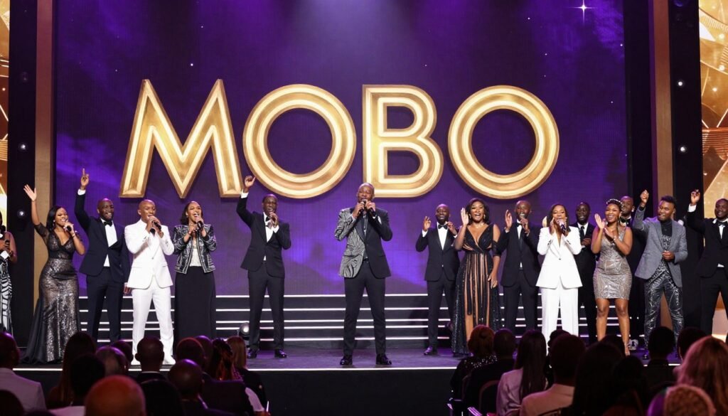 A wide shot of a glamorous music awards ceremony stage, vibrant purple and gold lighting, "MOBO" logo in the background, a diverse audience cheering for a performing artist.